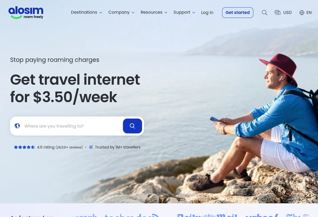 aloSIM homepage screenshot with a destination search and a traveller using a phone by the sea.